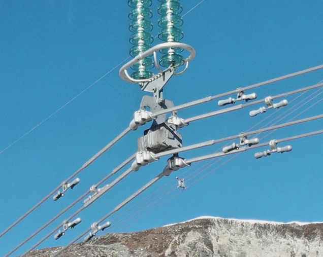 Visible spectrum image close up of lower part of electricity pylon insulator and Stockbridge dampers - compare to following thermal image